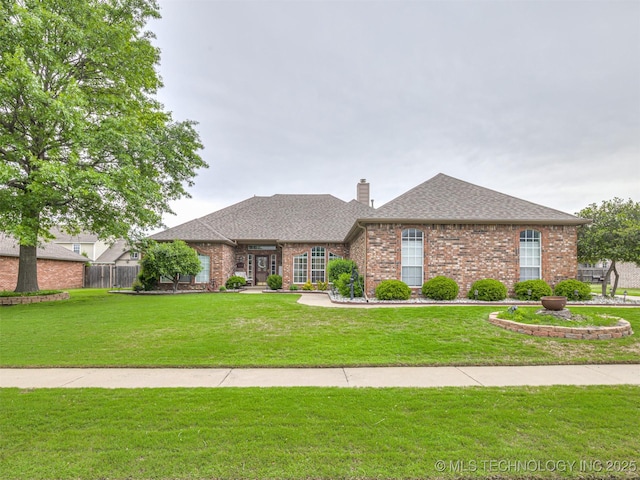 single story home with brick siding, a chimney, and a shingled roof