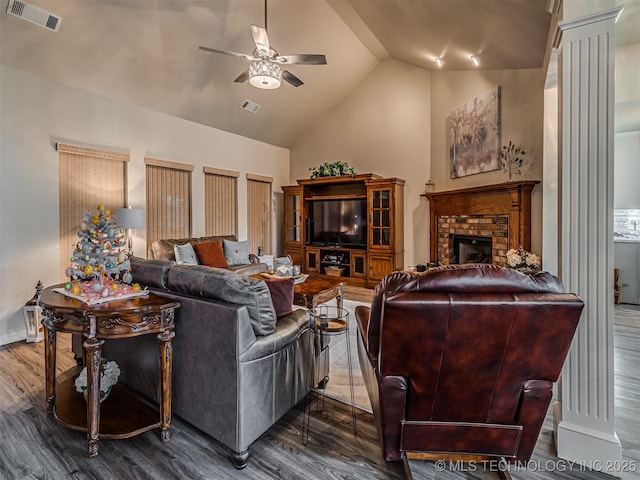 living room with ceiling fan, wood finished floors, a fireplace, high vaulted ceiling, and baseboards