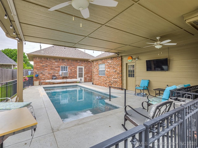 view of swimming pool featuring ceiling fan, fence, and a patio area
