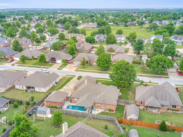 aerial perspective of suburban area featuring a pool