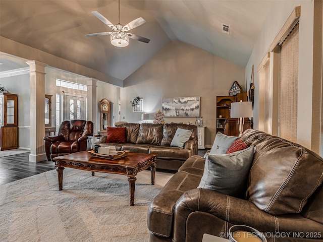 living room featuring a ceiling fan, decorative columns, wood finished floors, and vaulted ceiling