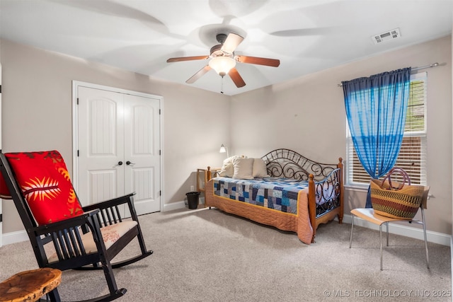 carpeted bedroom featuring baseboards, a closet, and ceiling fan