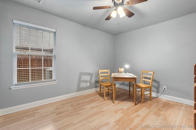 dining area featuring wood finished floors, baseboards, and a ceiling fan