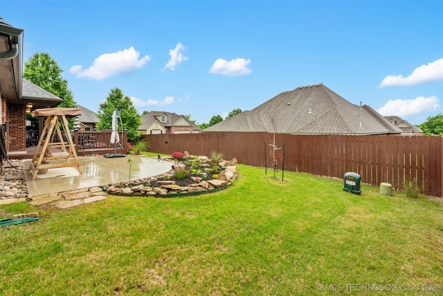 view of yard featuring a patio and a wooden deck