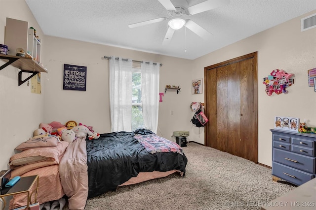 1205 Beaverly, Ardmore, OK 73401 - bedroom with carpet floors, a textured ceiling, a ceiling fan, and a closet