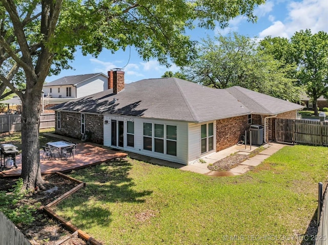 1205 Beaverly, Ardmore, OK 73401 - rear view of house featuring a chimney, cooling unit, brick siding, a deck, and roof with shingles