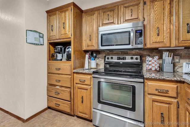 1205 Beaverly, Ardmore, OK 73401 - kitchen featuring appliances with stainless steel finishes, tasteful backsplash, and brown cabinets