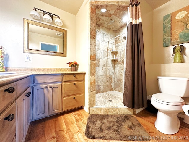 114537 Spring Creek Rd, Eufaula, OK 74432 - full bathroom featuring wood finished floors, a tile shower, toilet, and vanity