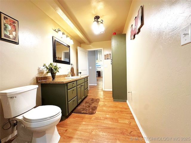 114537 Spring Creek Rd, Eufaula, OK 74432 - bathroom featuring wood finished floors, toilet, vanity, and baseboards