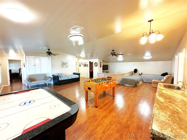 114537 Spring Creek Rd, Eufaula, OK 74432 - rec room with ceiling fan, vaulted ceiling, light wood-type flooring, a sink, and a chandelier