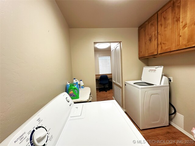 114537 Spring Creek Rd, Eufaula, OK 74432 - laundry area featuring washing machine and clothes dryer, cabinet space, wood finished floors, and a desk