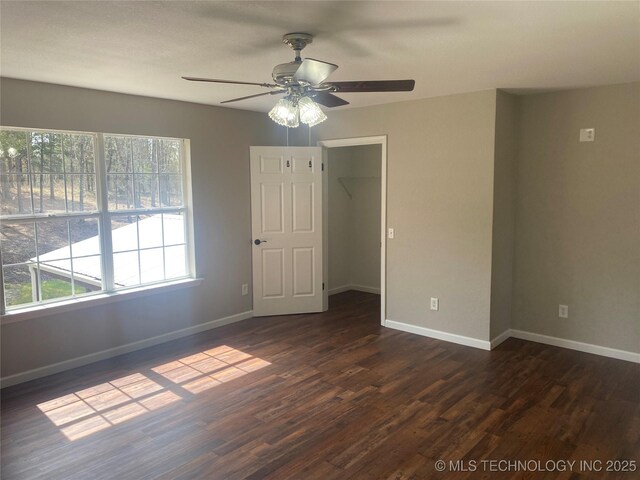 174550 N 4430th Rd N, Nashoba, OK 74558 - empty room with plenty of natural light, a ceiling fan, and dark wood-style floors