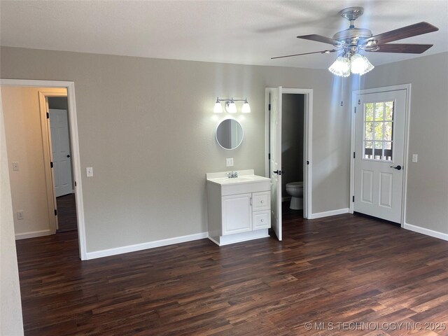174550 N 4430th Rd N, Nashoba, OK 74558 - empty room with dark wood-style floors, a ceiling fan, and baseboards