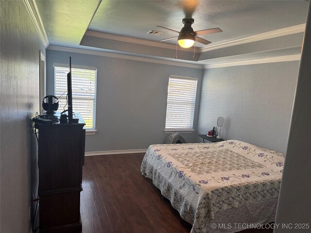 4715 Travertine, Ardmore, OK 73401 - bedroom with a tray ceiling, dark wood-style flooring, crown molding, ceiling fan, and baseboards