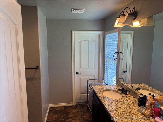 4715 Travertine, Ardmore, OK 73401 - bathroom featuring baseboards and vanity