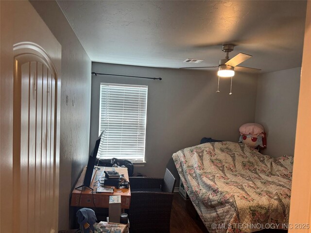 4715 Travertine, Ardmore, OK 73401 - bedroom with multiple windows, wood finished floors, and ceiling fan