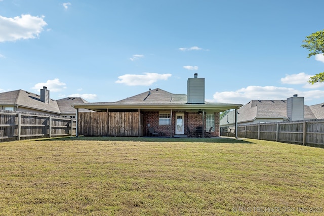rear view of house with a chimney and brick siding