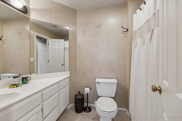 bathroom featuring toilet, tile patterned floors, and vanity