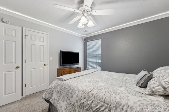 bedroom with carpet floors, ornamental molding, and ceiling fan