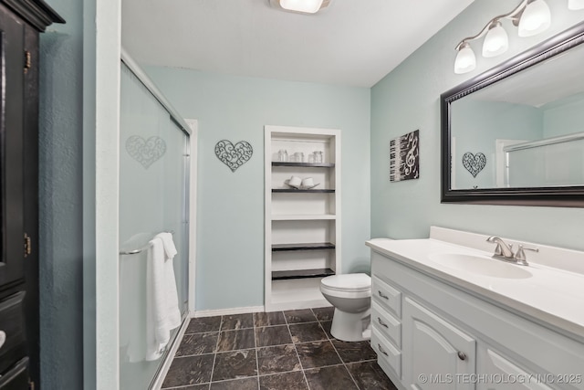 full bathroom featuring a stall shower, vanity, and toilet