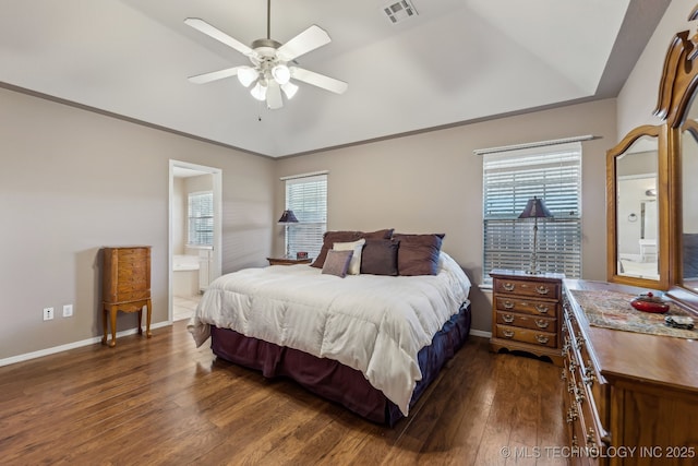 bedroom featuring dark wood-type flooring, baseboards, lofted ceiling, connected bathroom, and ceiling fan