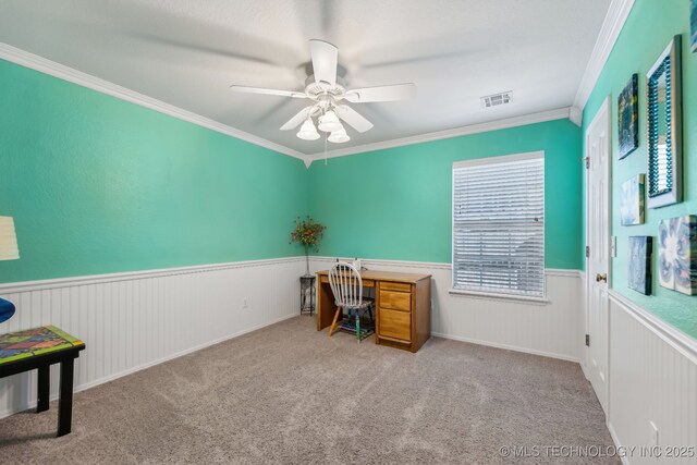 unfurnished office with crown molding, wainscoting, ceiling fan, and carpet floors