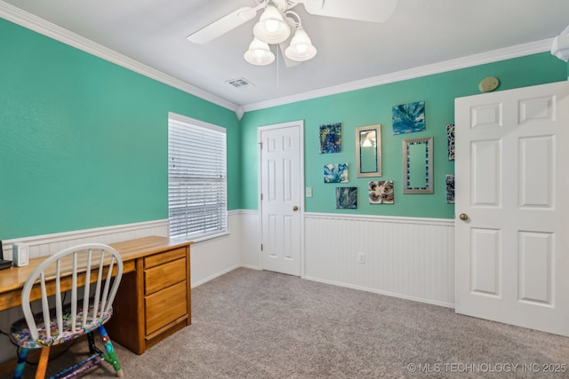 home office featuring ceiling fan, wainscoting, crown molding, and carpet