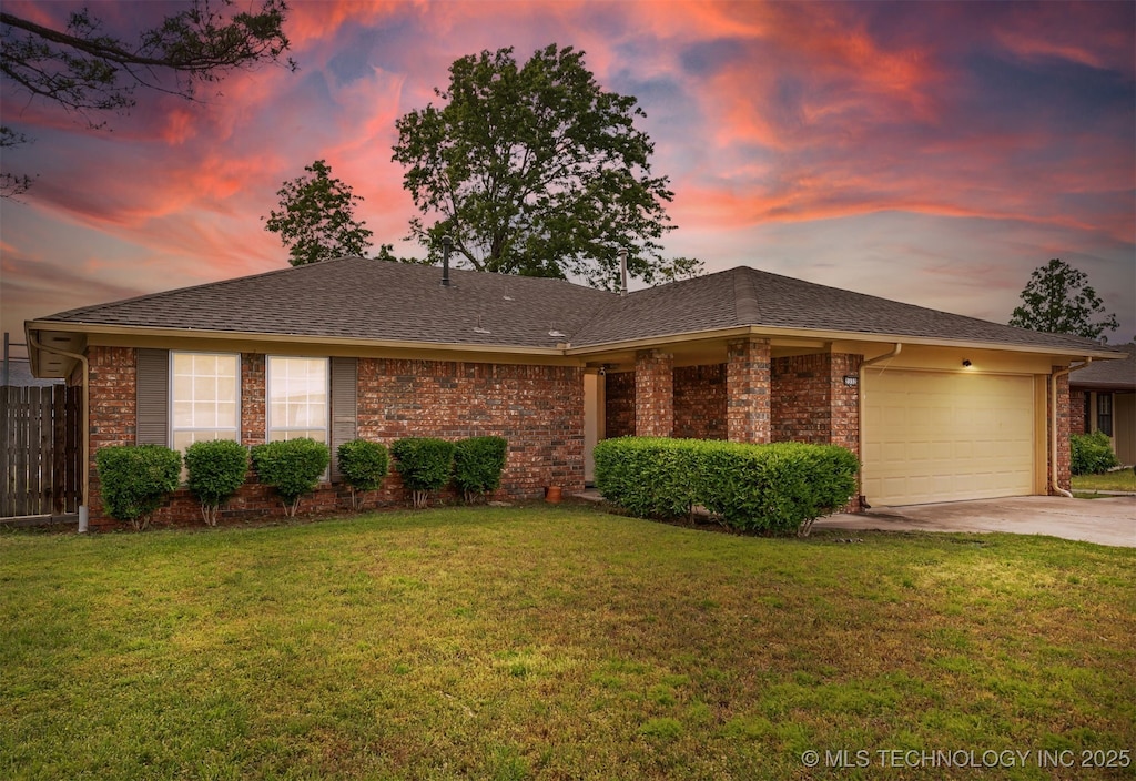 view of front of home featuring driveway, an attached garage, and brick siding