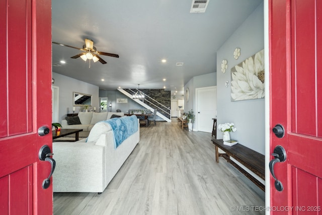foyer with stairway, wood finished floors, ceiling fan, and recessed lighting