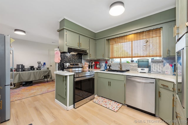 1014 SE 3rd St, Wagoner, OK 74467 - kitchen with appliances with stainless steel finishes, green cabinets, under cabinet range hood, and ornamental molding