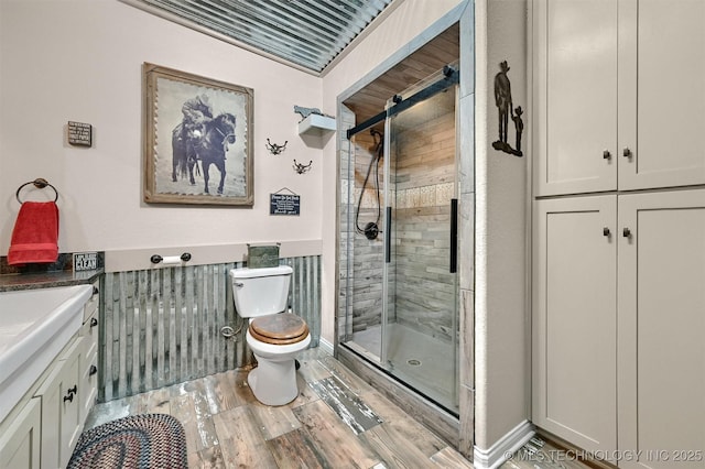 17983 Nuttin Ln, Madill, OK 73446 - full bath with a stall shower, toilet, vanity, and wood finished floors