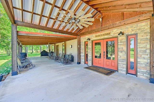 17983 Nuttin Ln, Madill, OK 73446 - entrance to property with stone siding, a ceiling fan, a patio area, and french doors