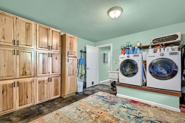 17983 Nuttin Ln, Madill, OK 73446 - laundry room featuring washer and dryer, cabinet space, a textured ceiling, and baseboards