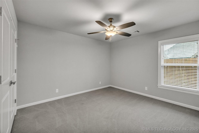 spare room featuring a ceiling fan, carpet flooring, and baseboards