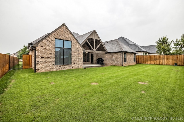 rear view of house featuring brick siding and a patio area