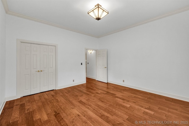 9304 E 113th St S, Bixby, OK 74008 - unfurnished bedroom with ornamental molding, wood finished floors, and a closet