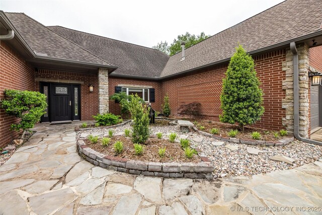 9304 E 113th St S, Bixby, OK 74008 - entrance to property featuring brick siding and roof with shingles