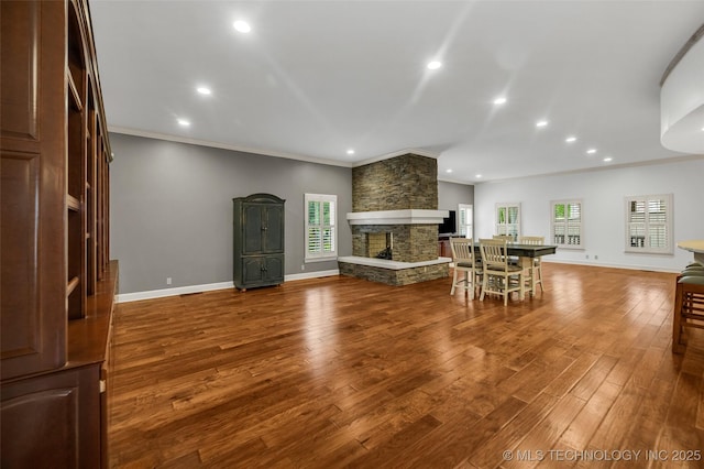 9304 E 113th St S, Bixby, OK 74008 - living room with healthy amount of natural light, recessed lighting, wood finished floors, ornamental molding, and a fireplace
