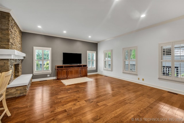 9304 E 113th St S, Bixby, OK 74008 - unfurnished living room featuring crown molding, wood finished floors, recessed lighting, and a stone fireplace
