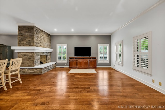 9304 E 113th St S, Bixby, OK 74008 - unfurnished living room with ornamental molding, a stone fireplace, wood finished floors, and recessed lighting