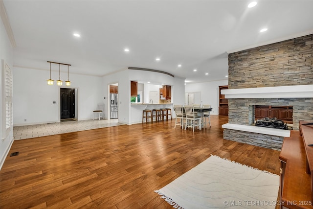 9304 E 113th St S, Bixby, OK 74008 - living room featuring light wood finished floors, a fireplace, recessed lighting, and crown molding