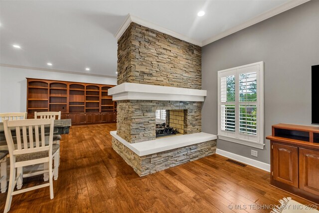 9304 E 113th St S, Bixby, OK 74008 - living area with a stone fireplace, crown molding, wood finished floors, and recessed lighting