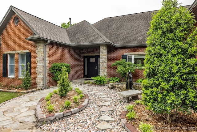 9304 E 113th St S, Bixby, OK 74008 - view of front of house featuring roof with shingles, brick siding, and stone siding