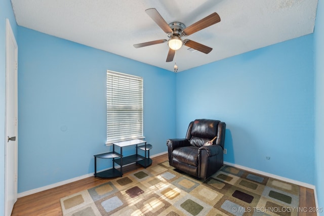 unfurnished room with wood finished floors, ceiling fan, and baseboards