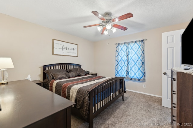bedroom featuring carpet flooring, baseboards, a ceiling fan, and a textured ceiling
