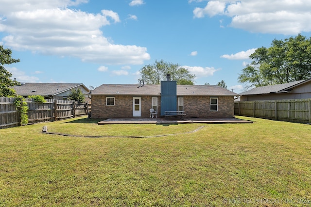 back of house with a deck, brick siding, and a chimney
