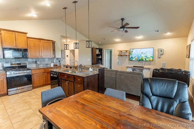 14708 E 108th St N, Owasso, OK 74055 - kitchen with black appliances, a sink, vaulted ceiling, a ceiling fan, and tasteful backsplash