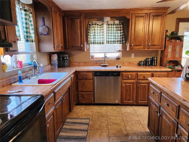 14360 County Road 3505th Loop, Ada, OK 74820 - kitchen with dishwasher, a sink, brown cabinetry, butcher block countertops, and black range with electric cooktop