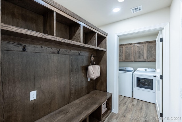 mudroom featuring washer and clothes dryer, light wood-style flooring, and recessed lighting