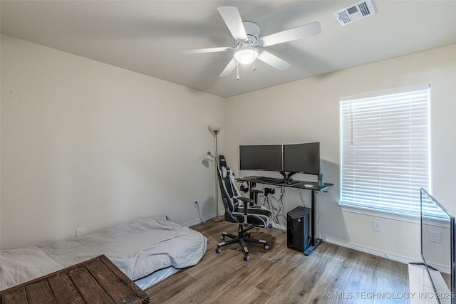 office with wood finished floors, ceiling fan, and baseboards